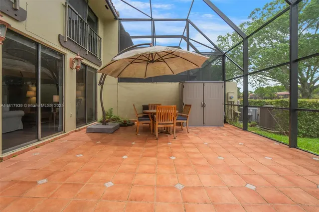 a backyard of a house with table and chairs