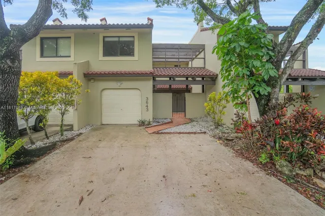a view of a house with a yard and plants