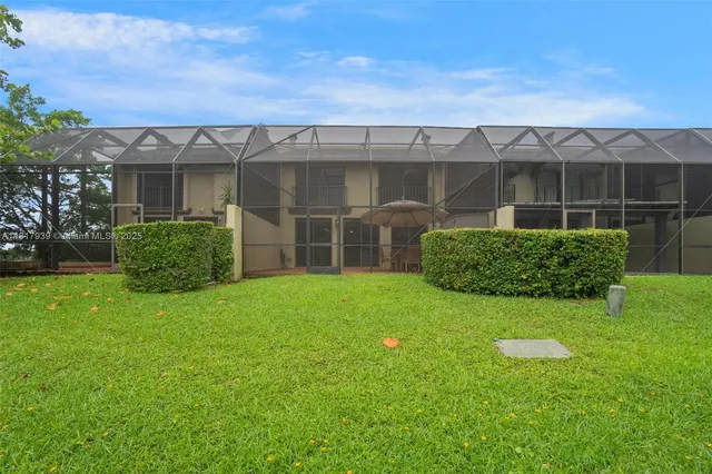 an aerial view of a house with a garden and a yard