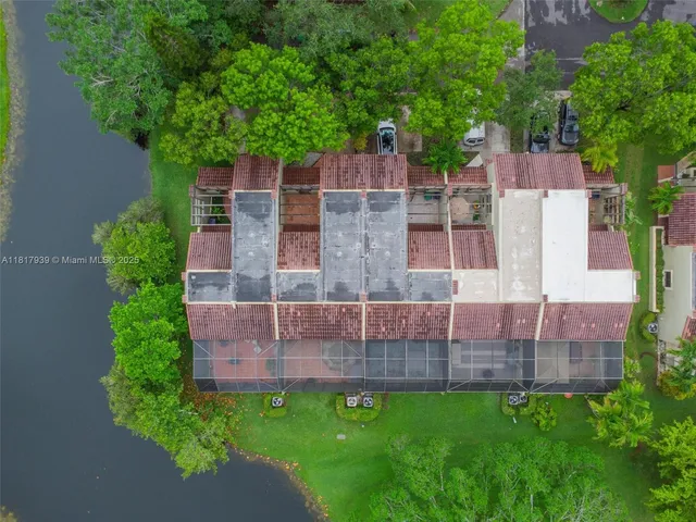 an aerial view of residential houses with outdoor space and street view