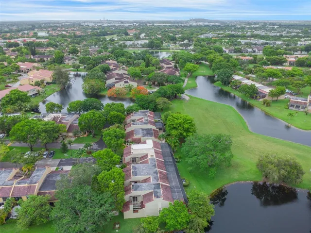an aerial view of a house with a yard and lake view