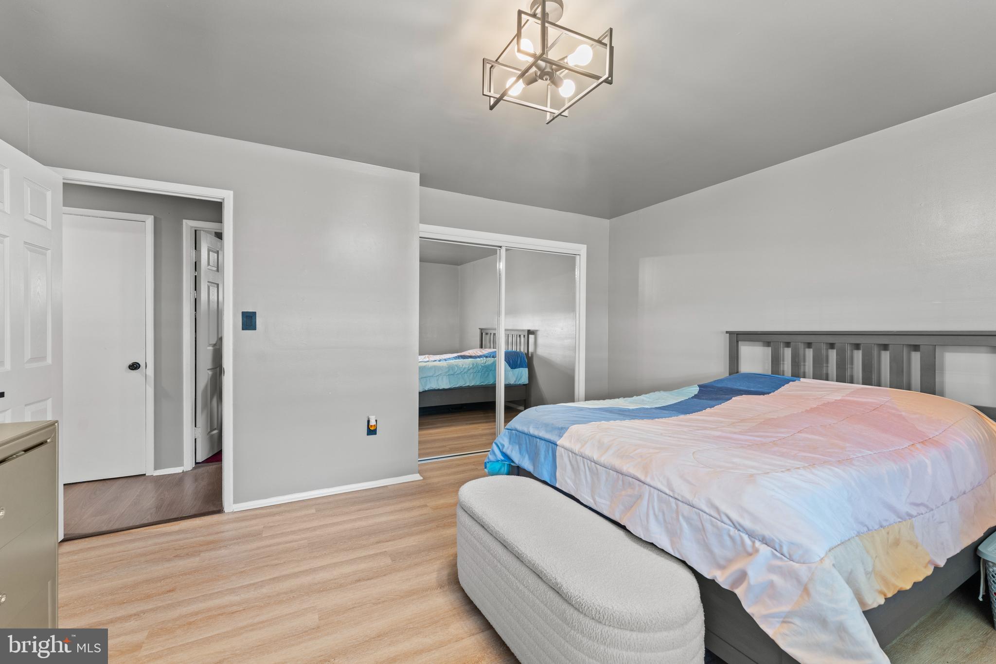 1922 Brookdale Road Baltimore, MD 21244 - Photo 15 of 33 a bedroom with a bed and a chandelier