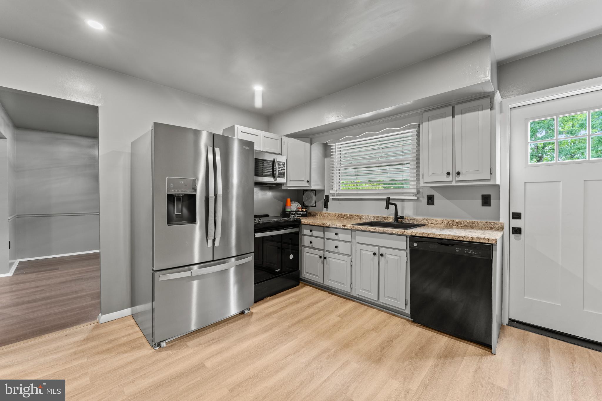 1922 Brookdale Road Baltimore, MD 21244 - Photo 7 of 33 a kitchen with granite countertop a refrigerator stove top oven and sink