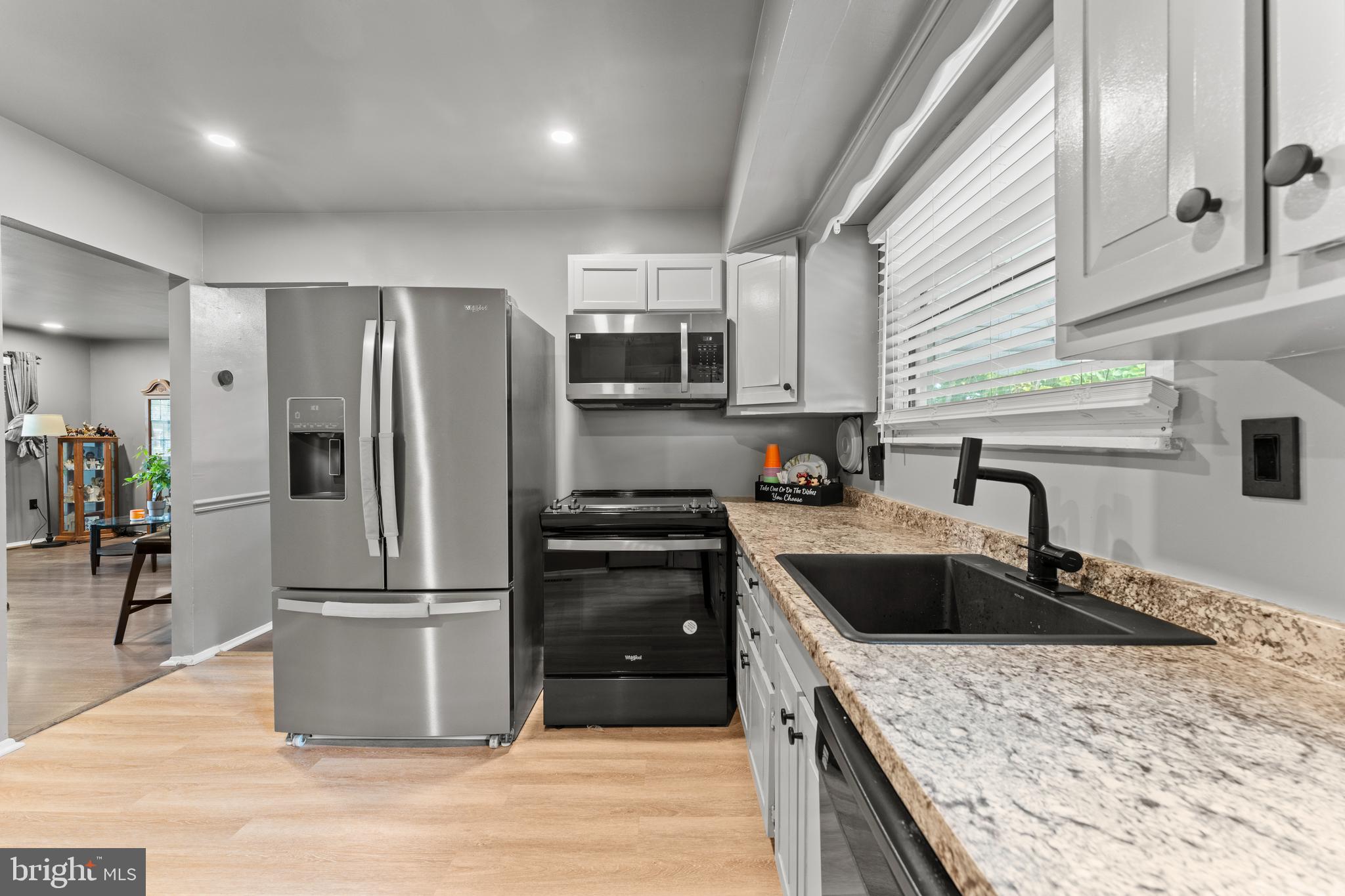 1922 Brookdale Road Baltimore, MD 21244 - Photo 8 of 33 a kitchen with granite countertop a refrigerator stove and sink