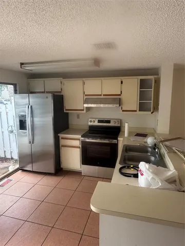 a kitchen with a stove a refrigerator and a sink
