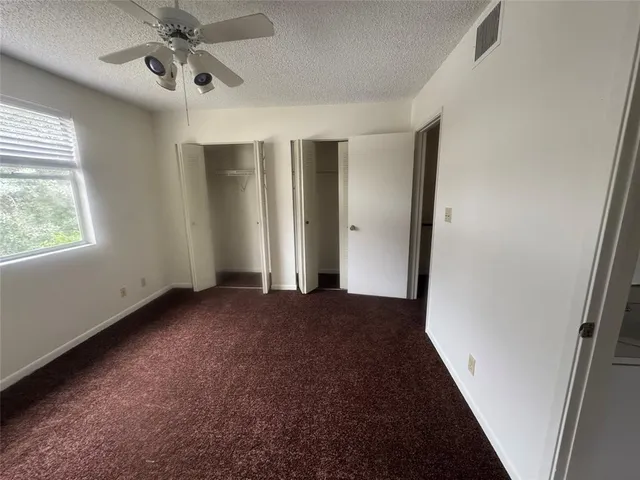 a view of an empty room and a window