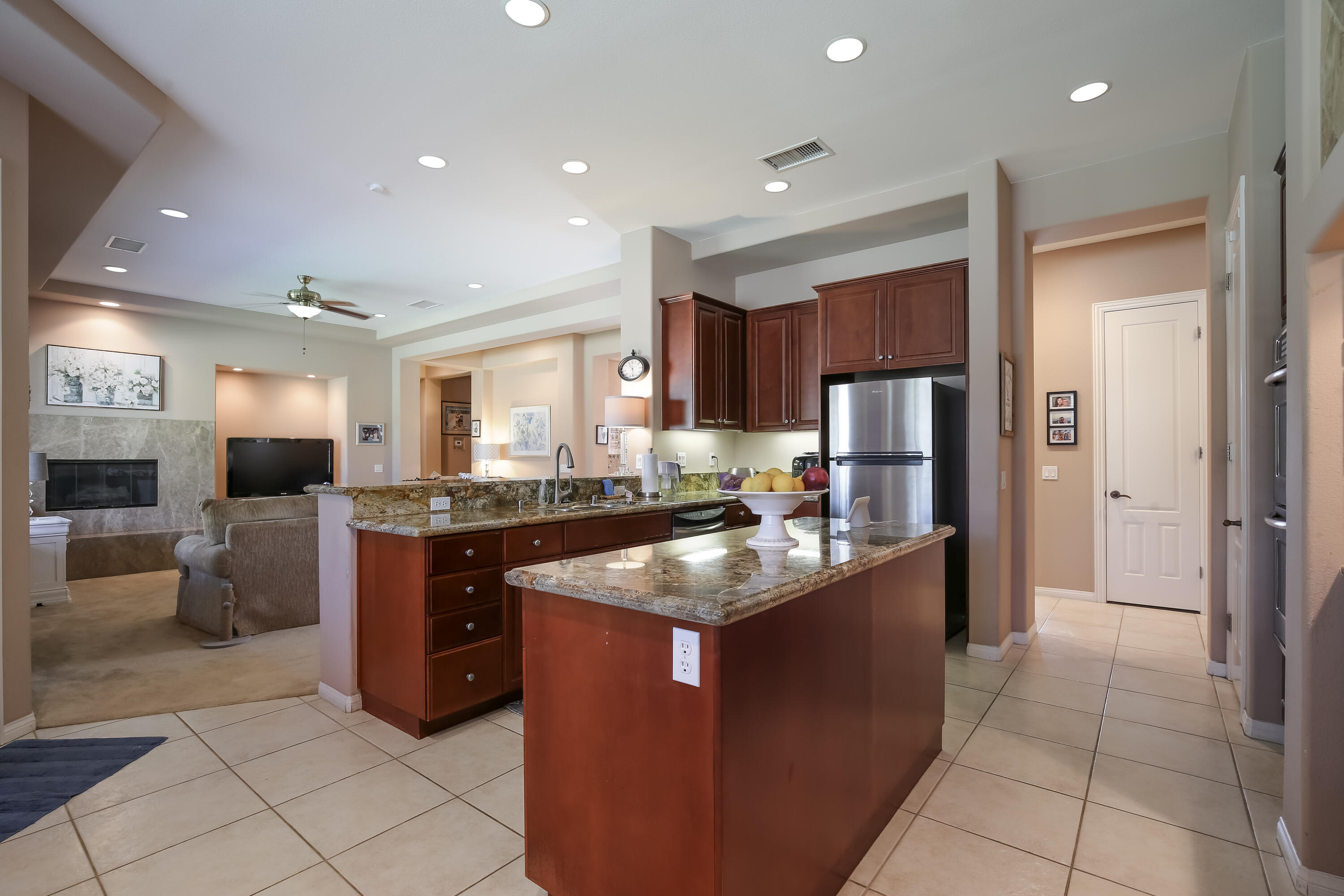 153 Bellini Way Palm Desert, CA 92211 - Photo 11 of 26 a kitchen with stainless steel appliances granite countertop a sink stove and refrigerator