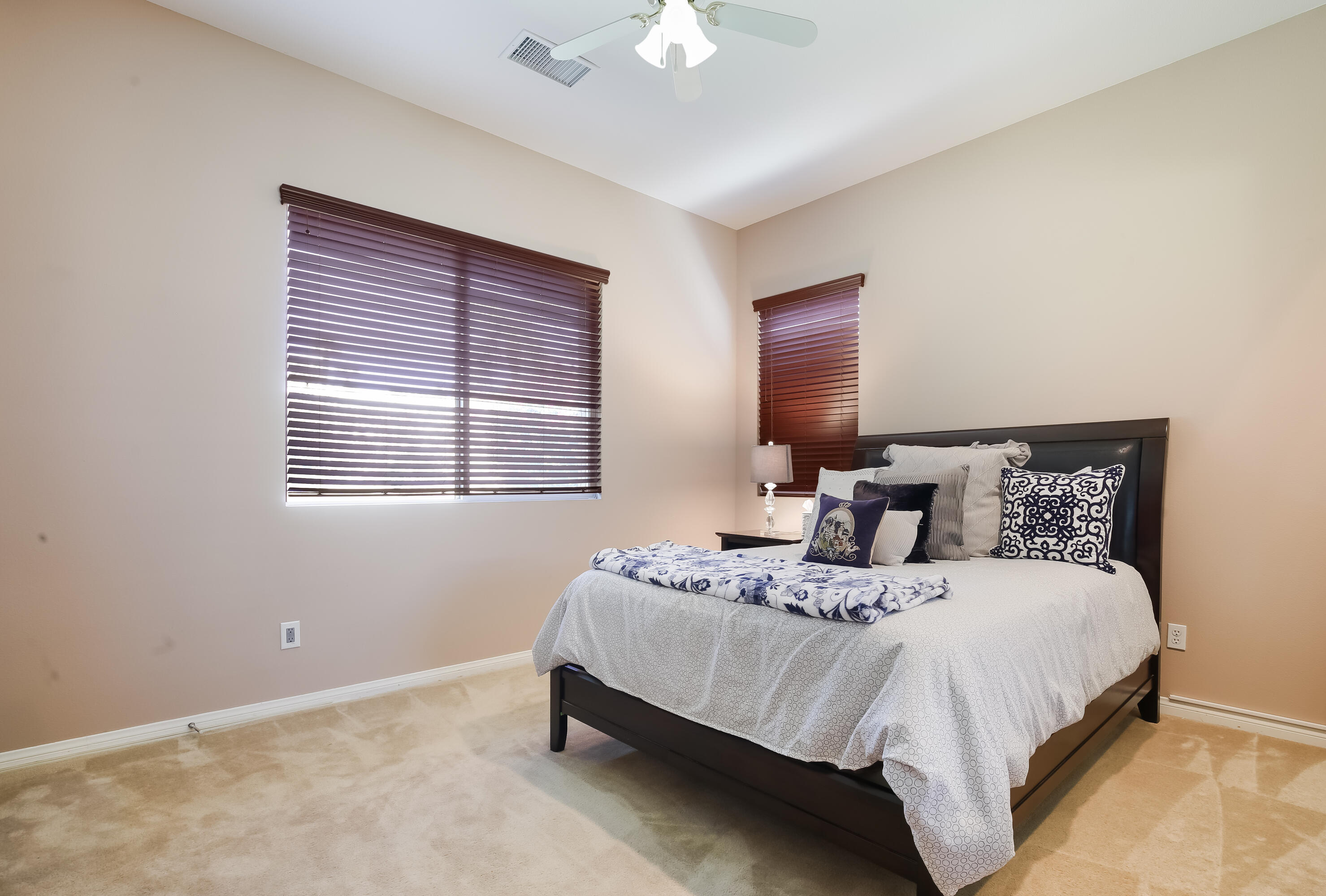 153 Bellini Way Palm Desert, CA 92211 - Photo 18 of 26 a bedroom with a bed and a chandelier