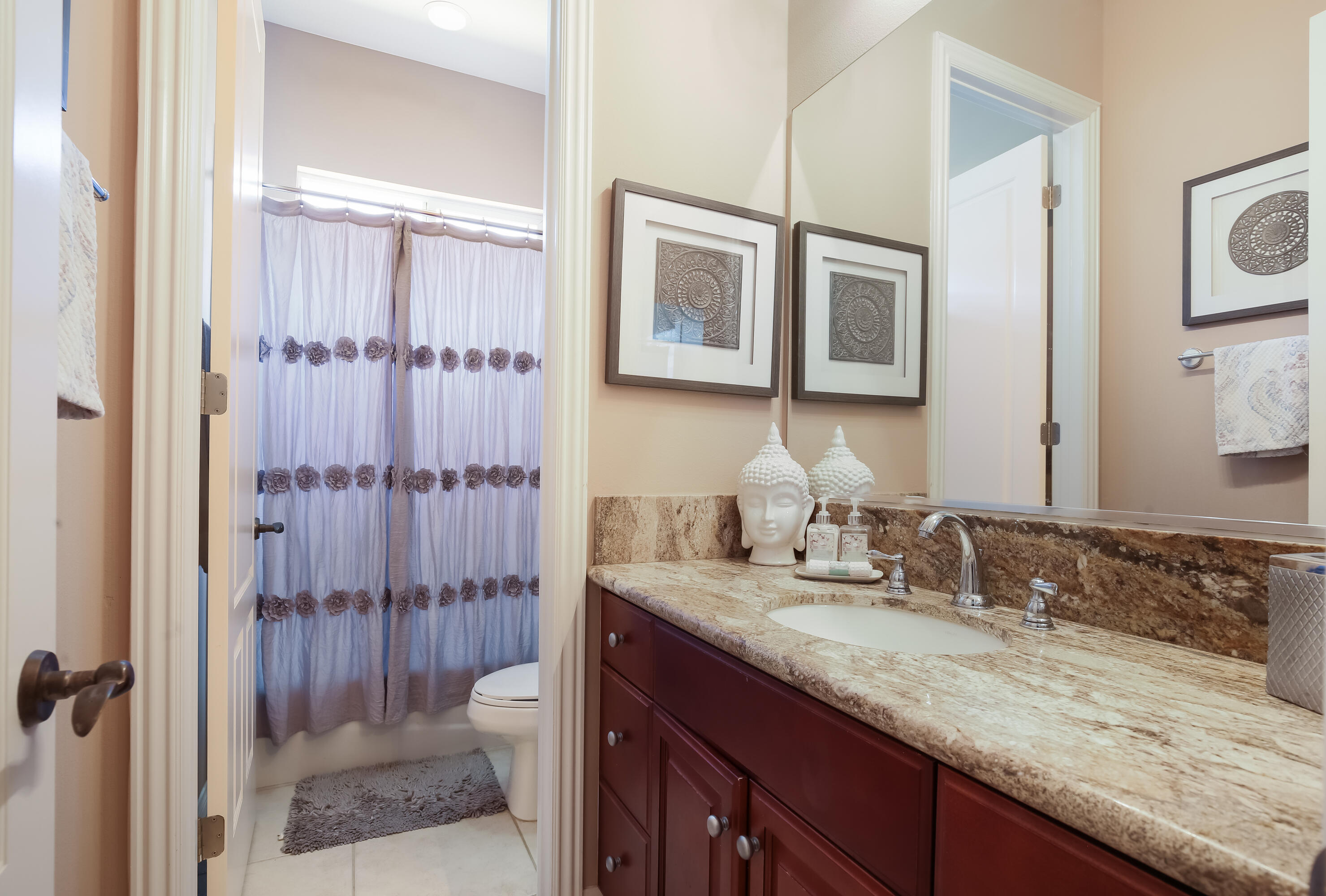 153 Bellini Way Palm Desert, CA 92211 - Photo 20 of 26 a bathroom with a granite countertop sink toilet a mirror a vanity and shower