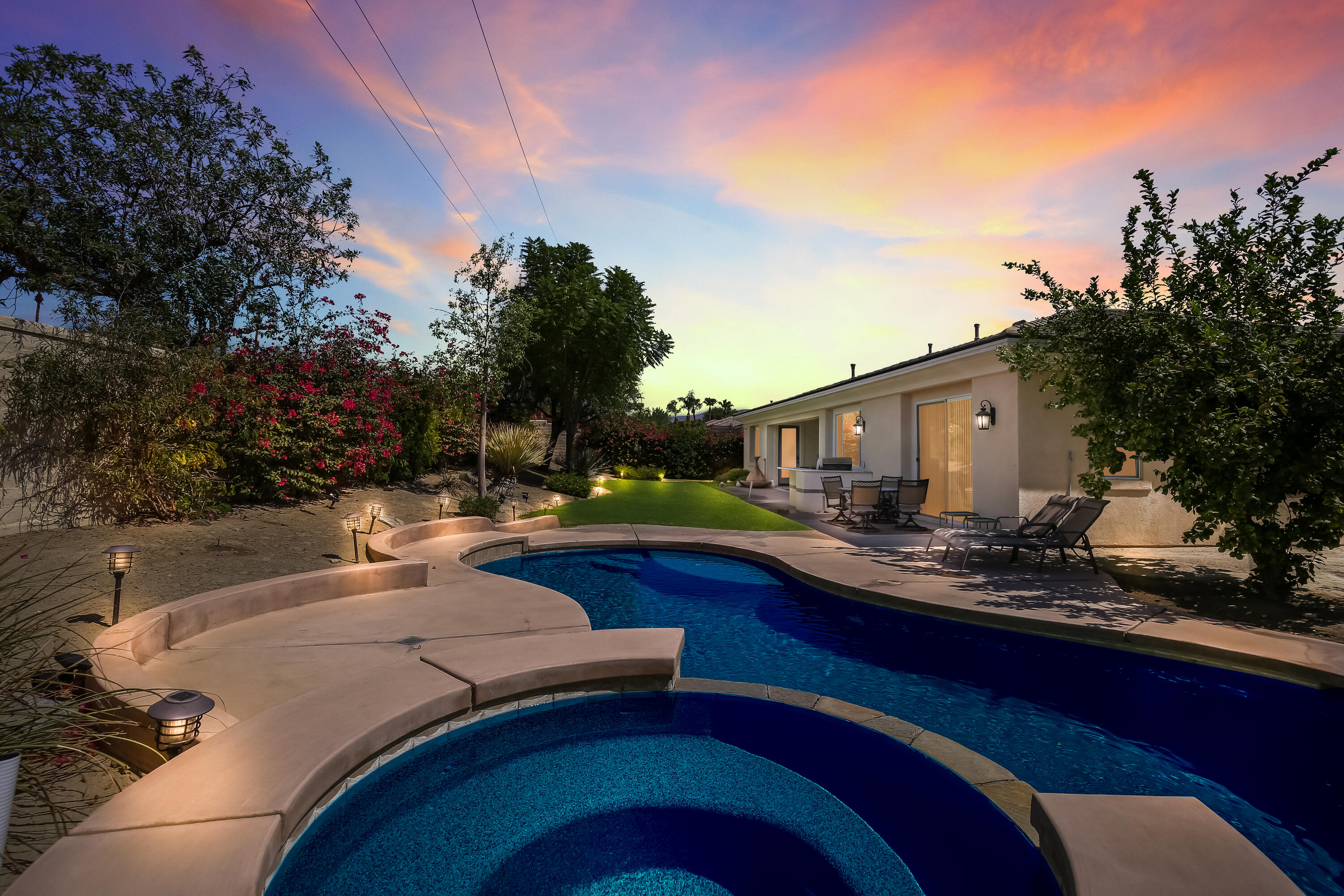 153 Bellini Way Palm Desert, CA 92211 - Photo 2 of 26 a view of a house with backyard and sitting area