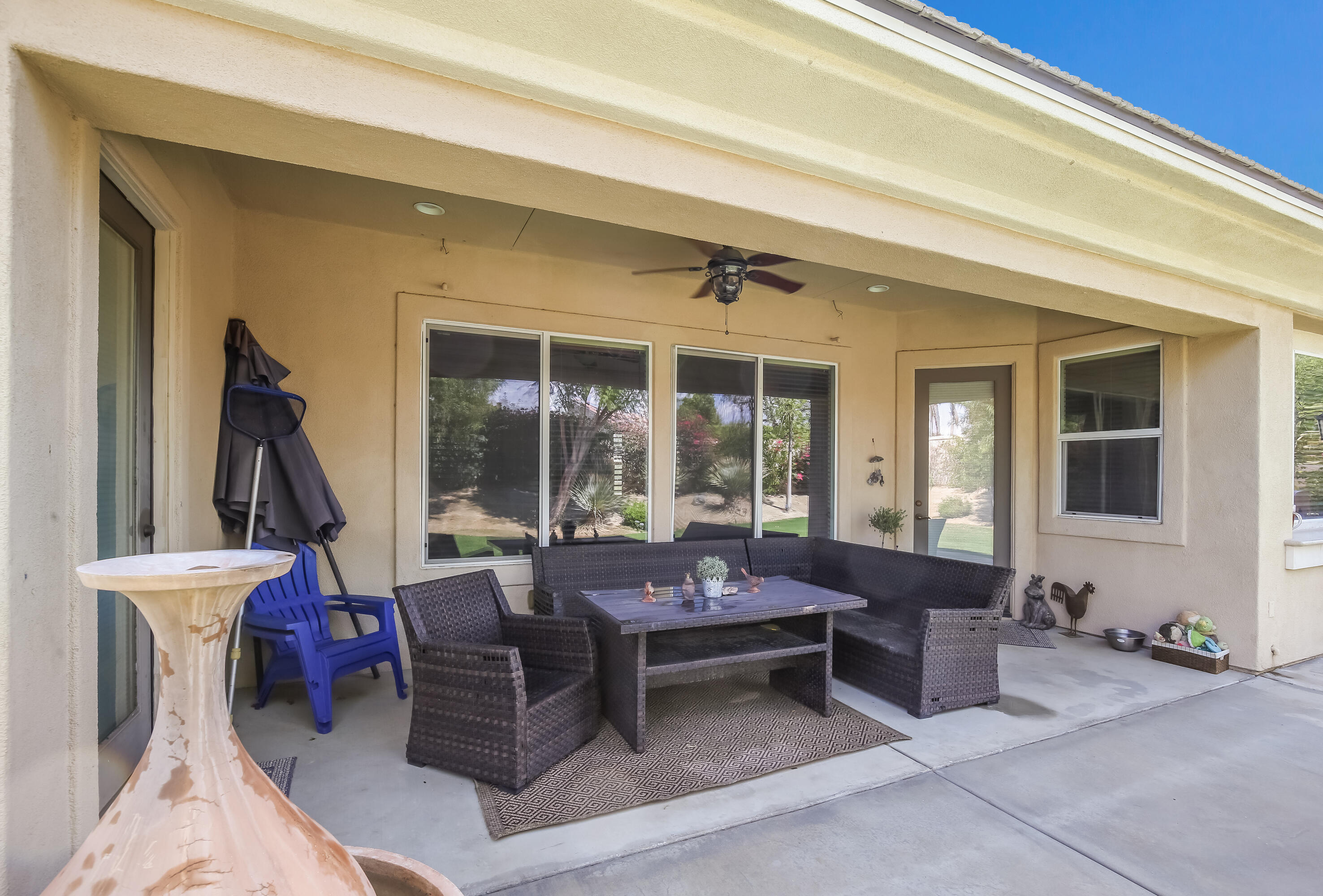 153 Bellini Way Palm Desert, CA 92211 - Photo 22 of 26 a living room with furniture a window and a table
