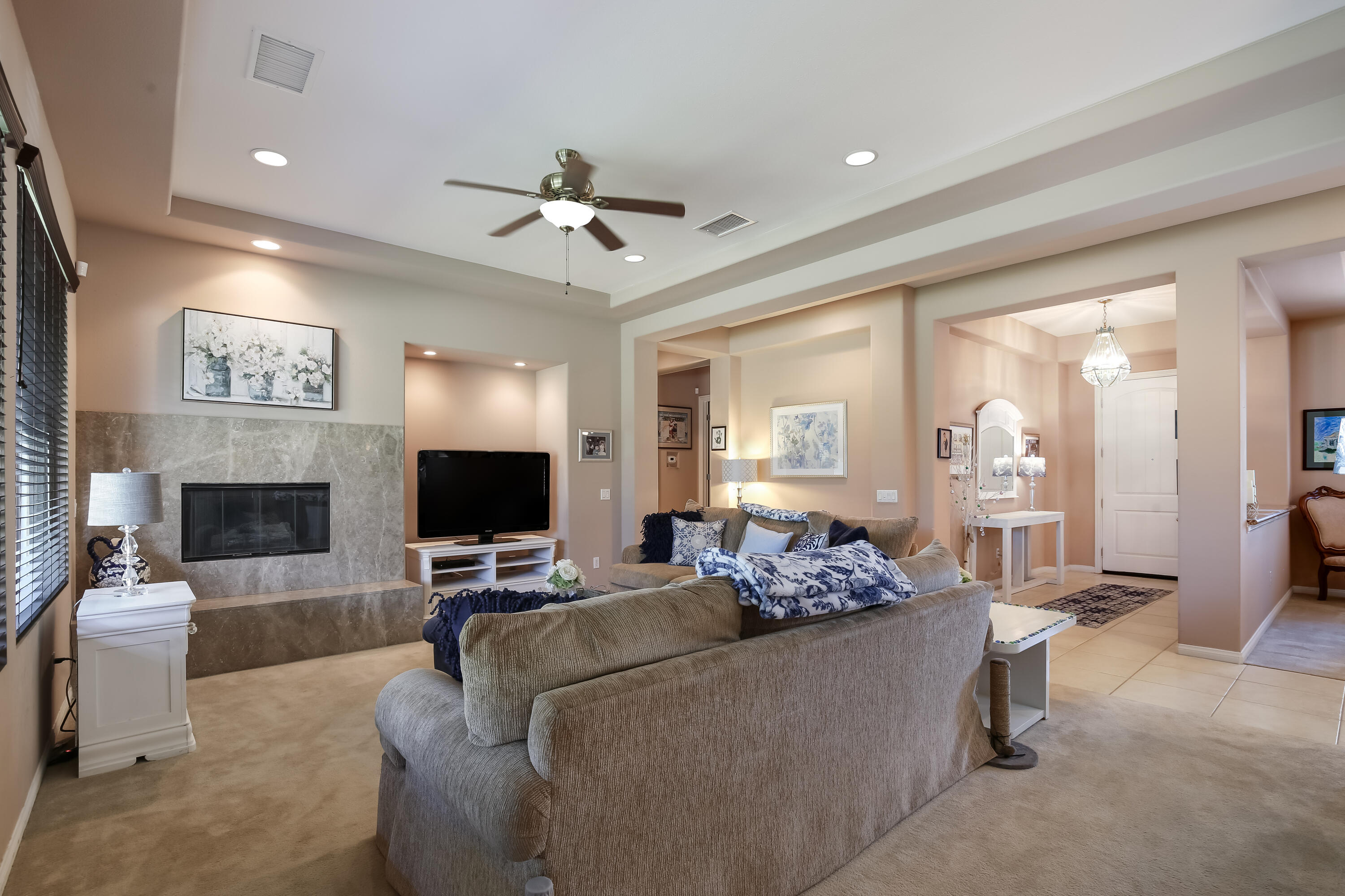 153 Bellini Way Palm Desert, CA 92211 - Photo 7 of 26 a living room with furniture and a fireplace