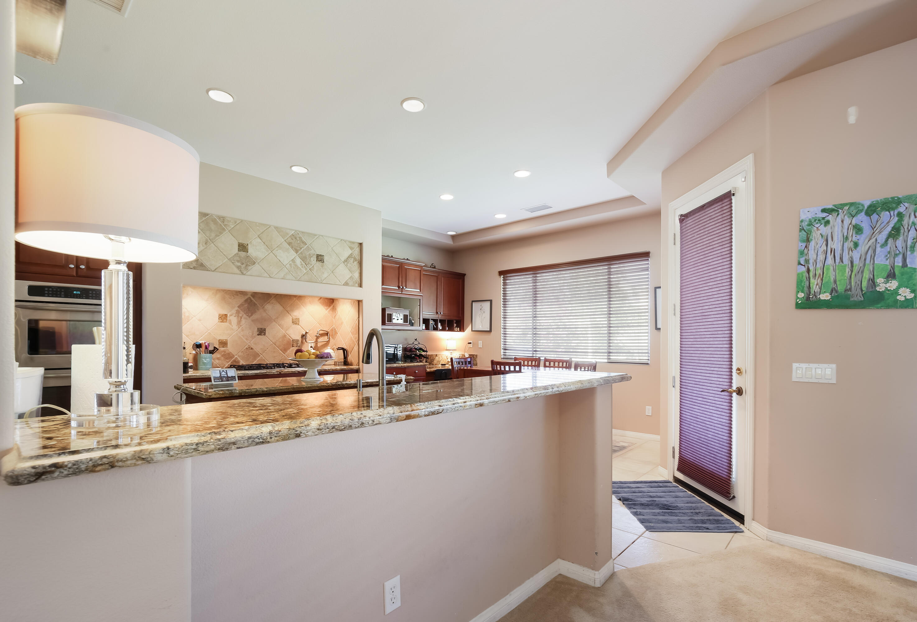 153 Bellini Way Palm Desert, CA 92211 - Photo 10 of 26 a kitchen with stainless steel appliances a sink stove and cabinets