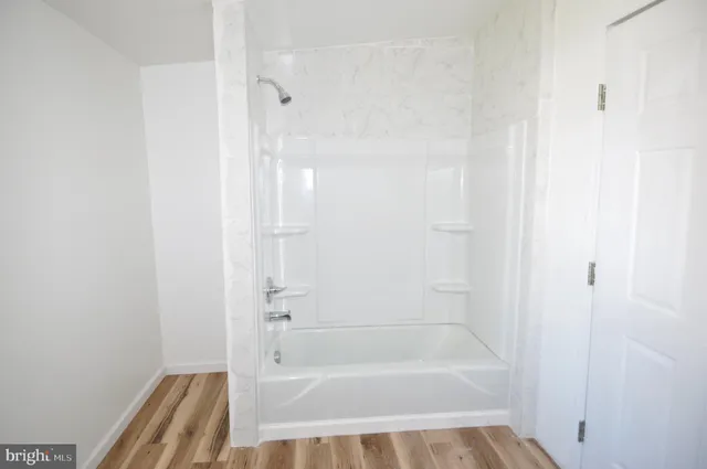 a bathroom with a shower and a bath tub