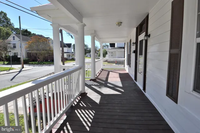 a view of a balcony with wooden floor