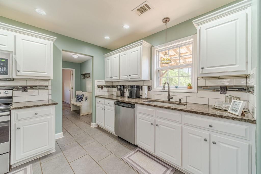 536 San Dra Way Monroe, GA 30656 - Photo 11 of 30 a kitchen with granite countertop white cabinets white appliances and a sink
