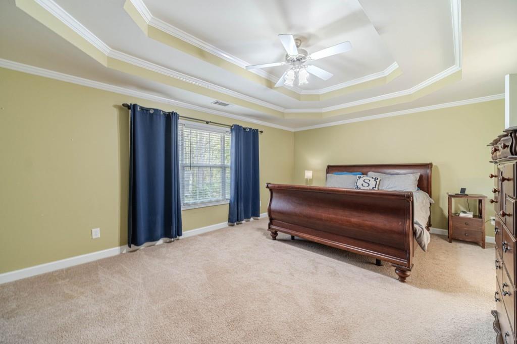 536 San Dra Way Monroe, GA 30656 - Photo 19 of 30 a bedroom with a bed and a chandelier
