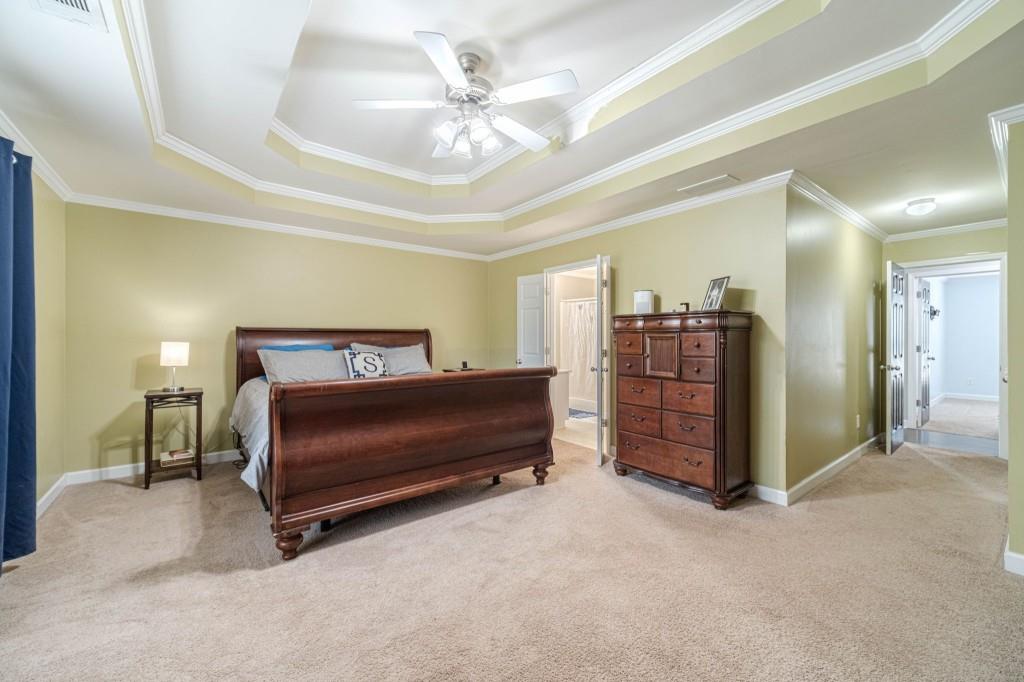 536 San Dra Way Monroe, GA 30656 - Photo 20 of 30 a bedroom with a bed a lamp and a chandelier