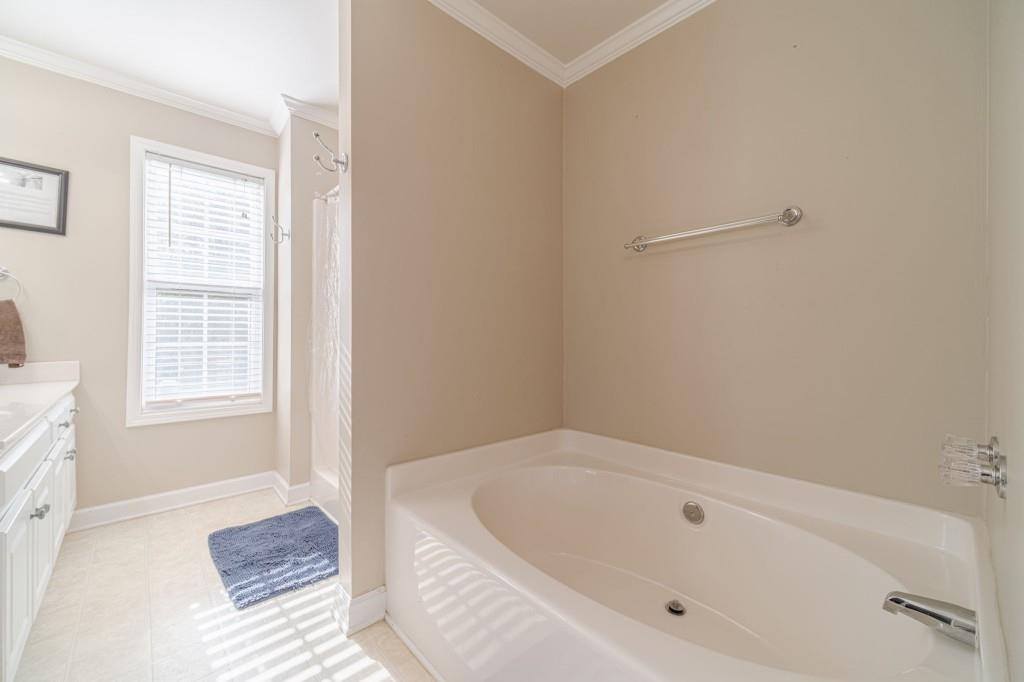 536 San Dra Way Monroe, GA 30656 - Photo 23 of 30 a bathroom with a tub and a window