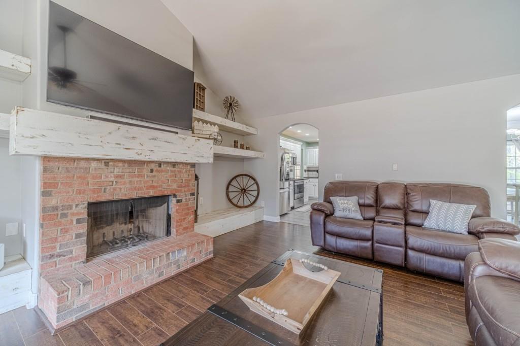 536 San Dra Way Monroe, GA 30656 - Photo 6 of 30 a living room with furniture a flat screen tv and a fireplace