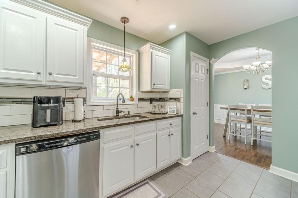 536 San Dra Way Monroe, GA 30656 - Photo 10 of 30 a kitchen with stainless steel appliances granite countertop a stove a sink and a refrigerator