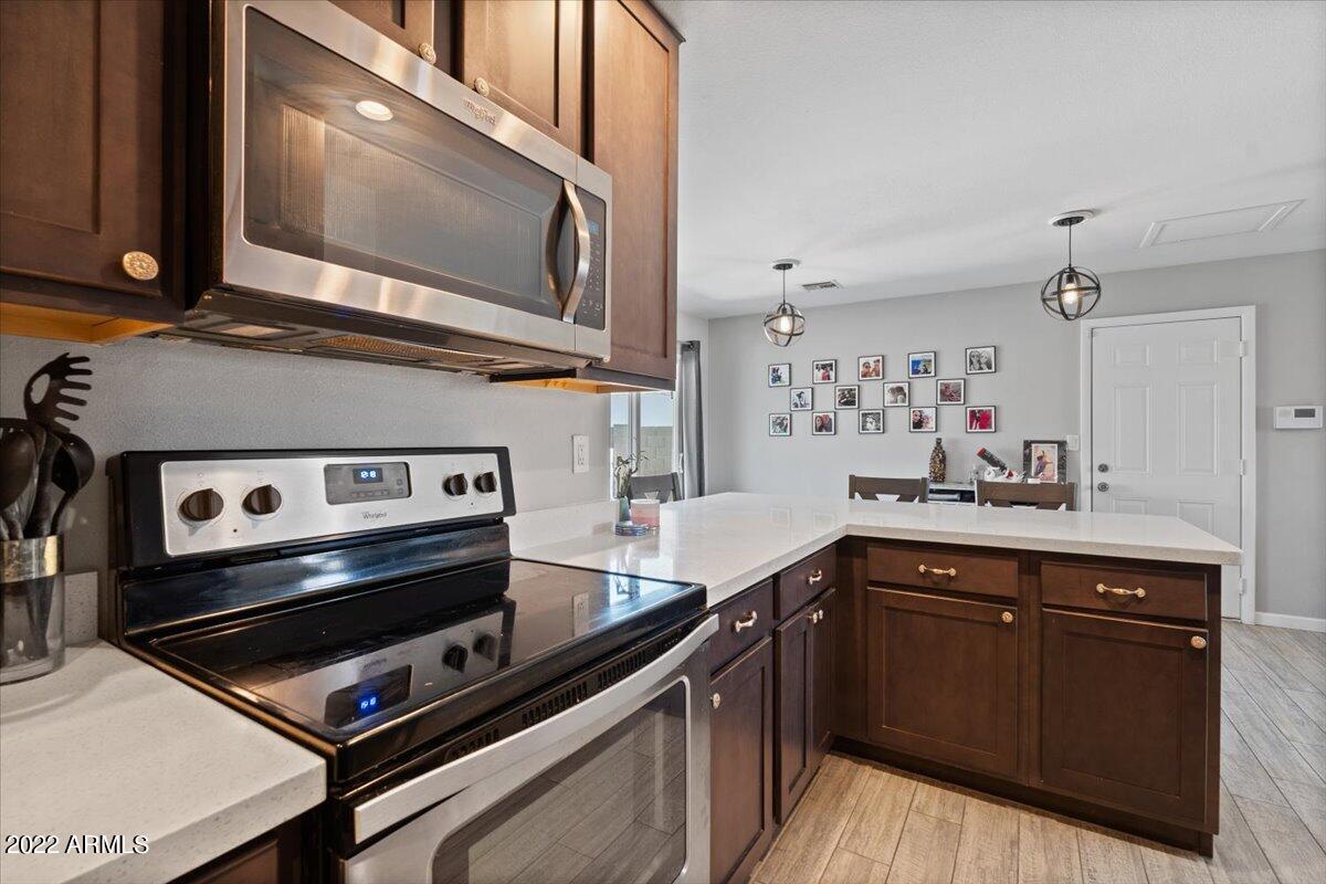 3308 East Charter Oak Road Phoenix, AZ 85032 - Photo 3 of 24 a kitchen with a stove microwave and sink