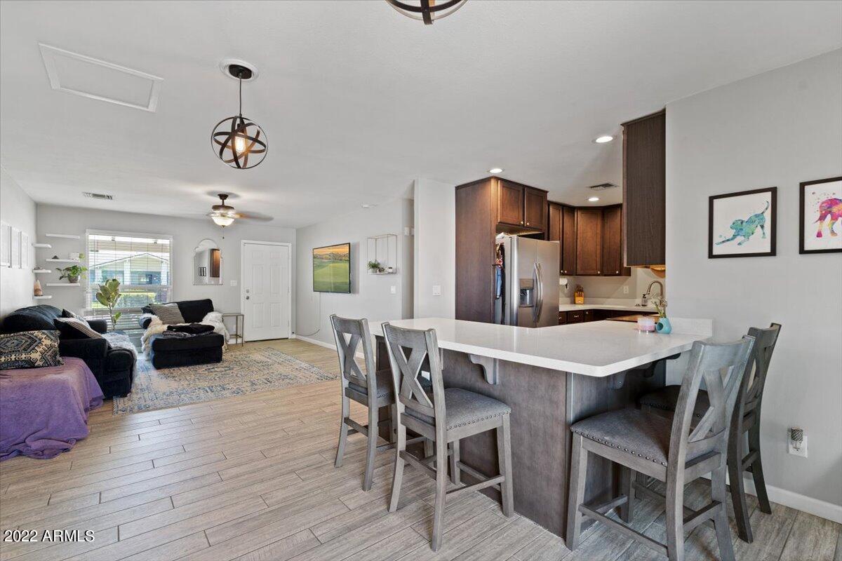 3308 East Charter Oak Road Phoenix, AZ 85032 - Photo 6 of 24 a view of a dining room with furniture and wooden floor