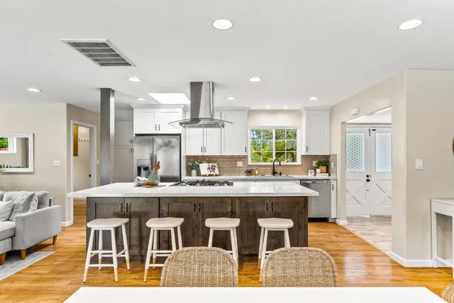 a large kitchen with a table and chairs