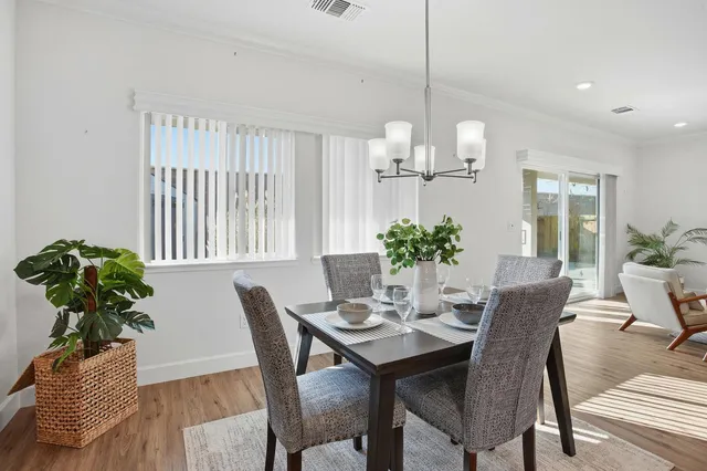 a view of a dining room with furniture window and wooden floor