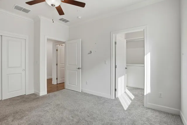 a view of empty room with ceiling fan