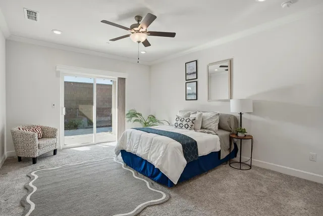 a spacious bedroom with a bed and a chandelier