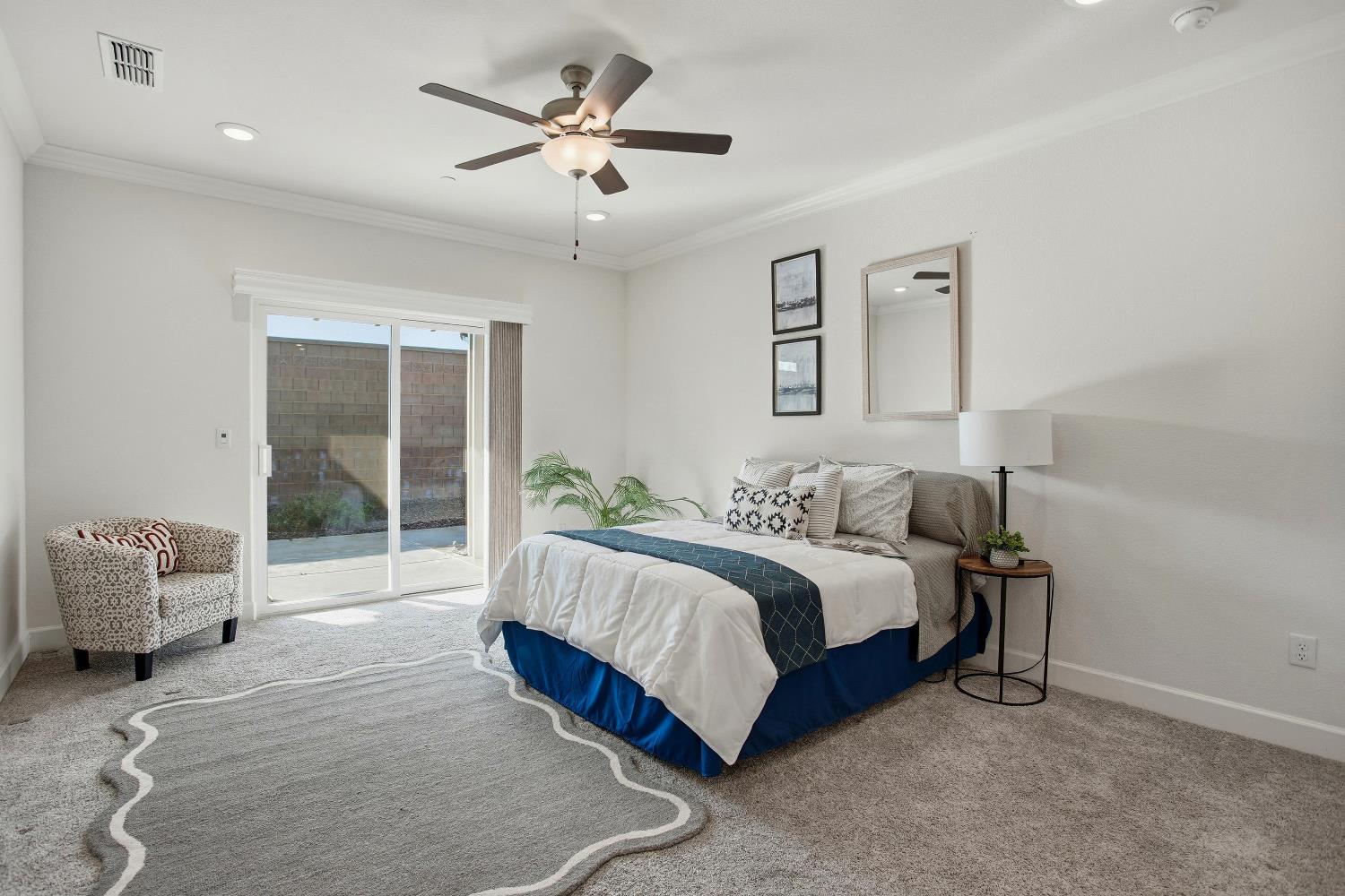 1112 Audrey Court Galt, CA 95632 - Photo 17 of 37 a spacious bedroom with a bed and a chandelier