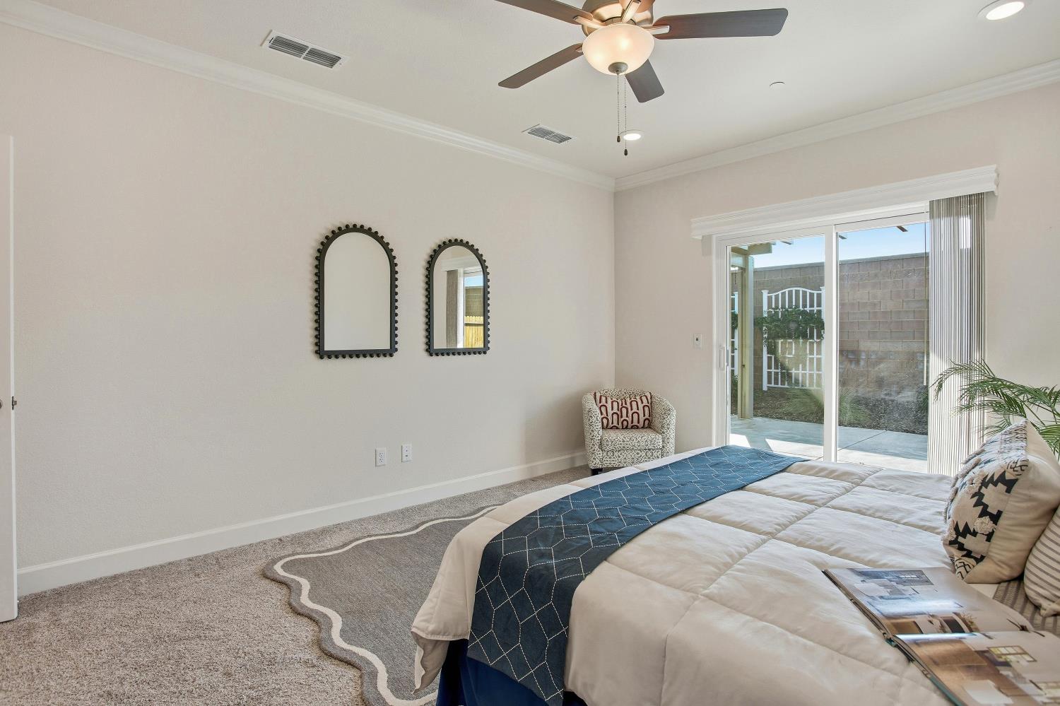 1112 Audrey Court Galt, CA 95632 - Photo 18 of 37 a bedroom with a large bed and a chandelier