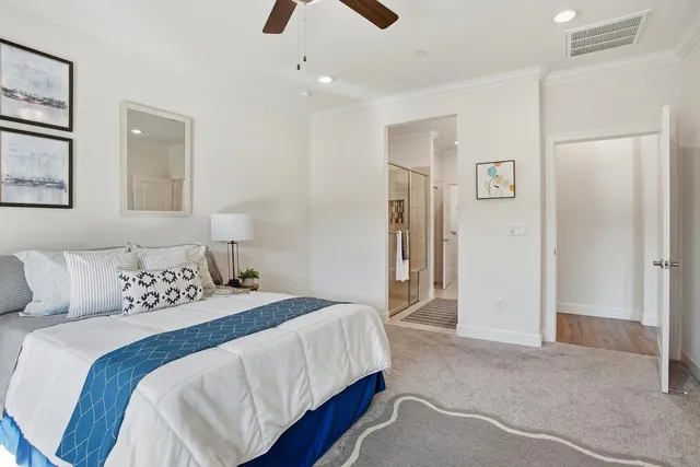 a bedroom with a large bed and a chandelier