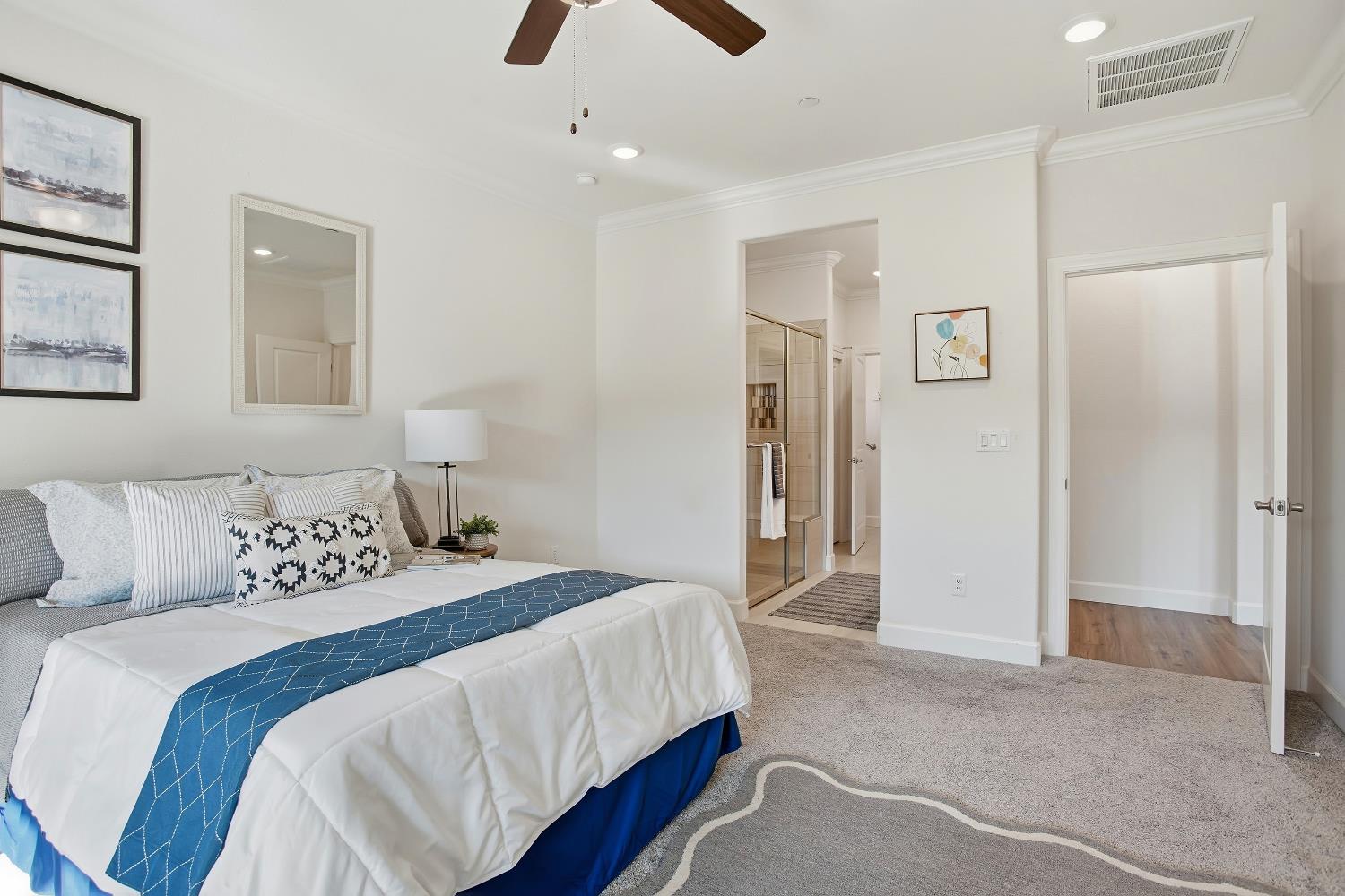 1112 Audrey Court Galt, CA 95632 - Photo 19 of 37 a bedroom with a large bed and a chandelier