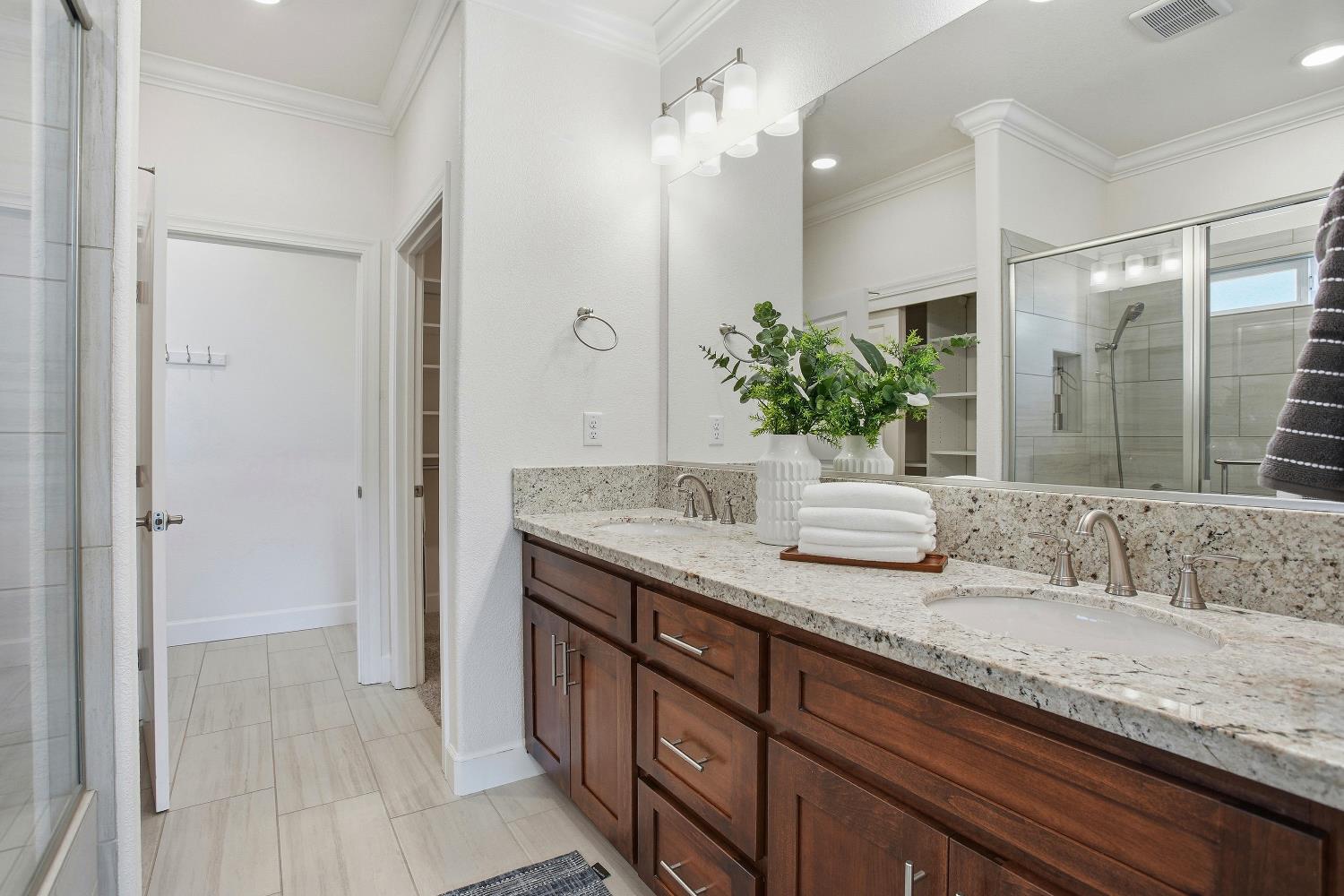 1112 Audrey Court Galt, CA 95632 - Photo 24 of 37 a bathroom with a granite countertop sink and a mirror