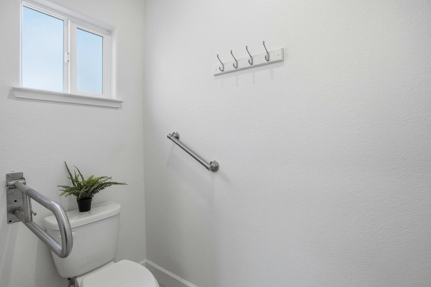 1112 Audrey Court Galt, CA 95632 - Photo 25 of 37 a white toilet sitting next to a white wall