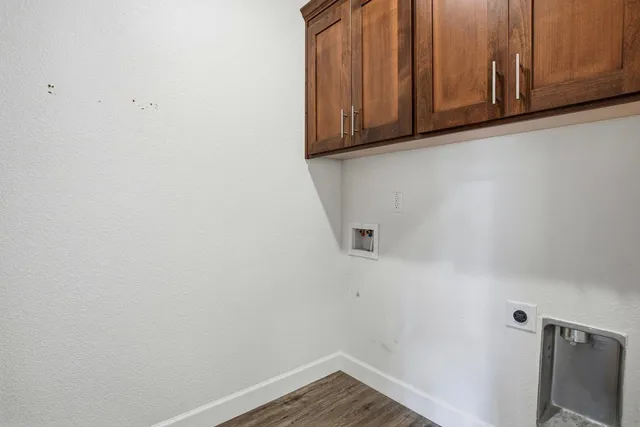 a view of storage and utility room with wooden floor