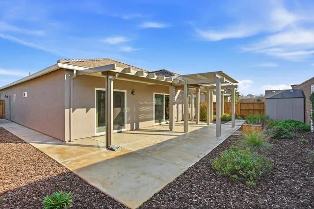 a view of a house with backyard and porch