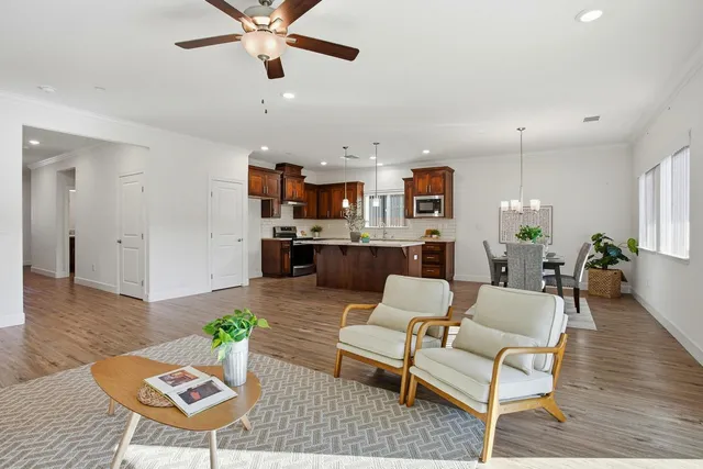 a living room with furniture and a wooden floor