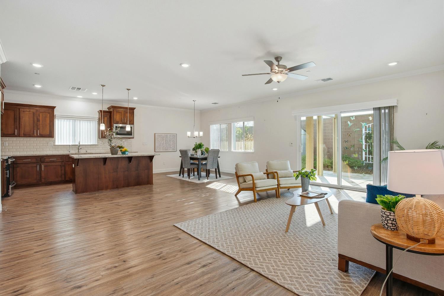 1112 Audrey Court Galt, CA 95632 - Photo 5 of 37 a living room with furniture kitchen view and a wooden floor