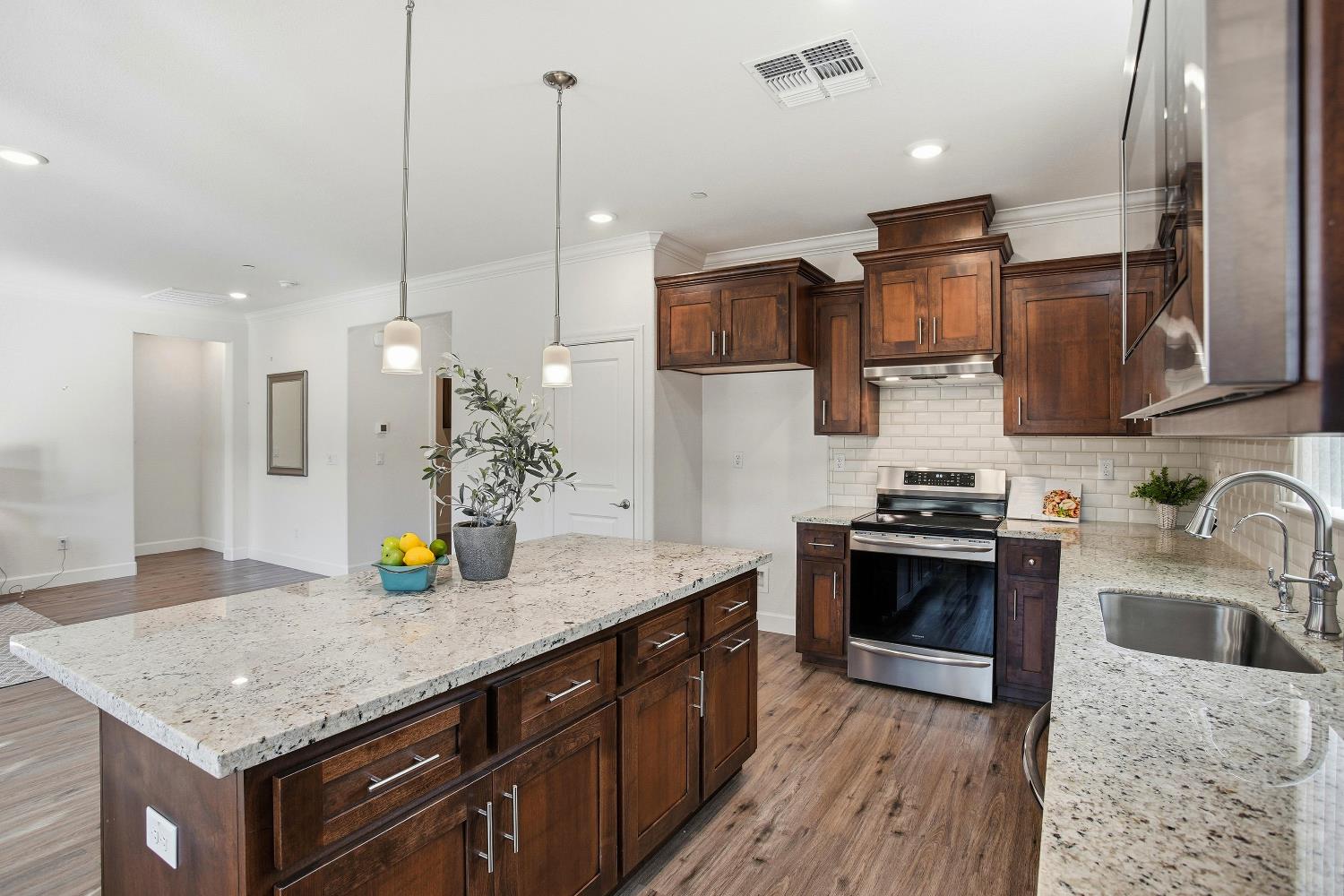1112 Audrey Court Galt, CA 95632 - Photo 6 of 37 a kitchen with a sink a stove and cabinets