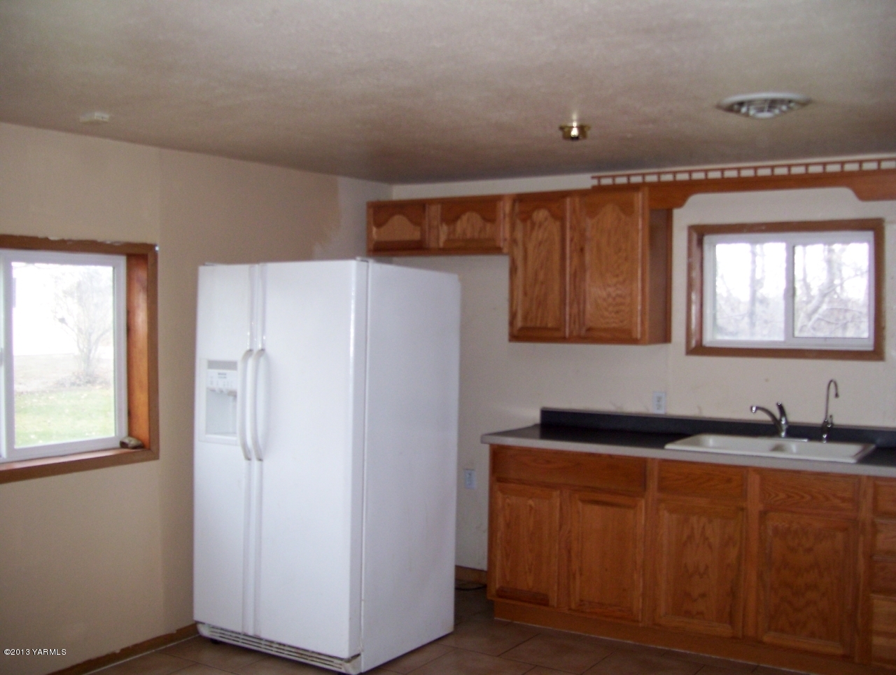 166902 West Johnson Road Prosser, WA 99350 - Photo 11 of 29 a white refrigerator freezer sitting inside of a kitchen