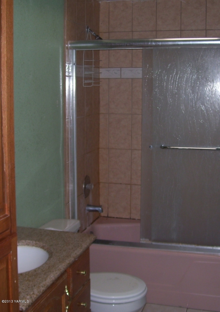 166902 West Johnson Road Prosser, WA 99350 - Photo 16 of 29 a bathroom with a granite countertop sink toilet and shower