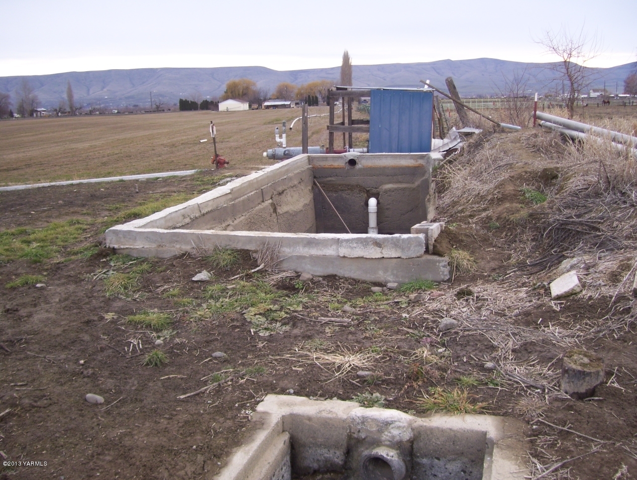 166902 West Johnson Road Prosser, WA 99350 - Photo 26 of 29 a view of a house with a yard and a car park in the back