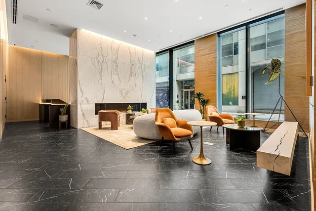 a living room filed with furniture and large window