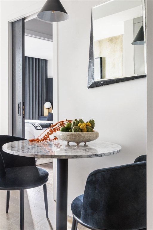 55 Lagrange Street, Unit 1203 Boston, MA 02116 - Photo 3 of 18 a room with a table and chairs