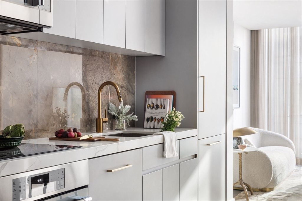 55 Lagrange Street, Unit 1203 Boston, MA 02116 - Photo 4 of 18 a kitchen with a sink and a mirror