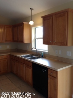 8400 F Reid Road Hastings, FL 32145 - Photo 5 of 13 a kitchen with stainless steel appliances granite countertop a sink a stove and a microwave