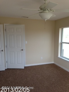 8400 F Reid Road Hastings, FL 32145 - Photo 8 of 13 an empty room with windows and fan